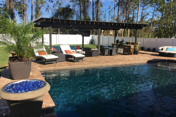 Backyard pool with pergola and firepit